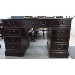 A modern reproduction of a 19thC mahogany desk, the top with a tooled, gilded hide scriber,