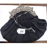 An early 20thC pleated and lined black satin evening purse with a decoratively cast Sterling silver