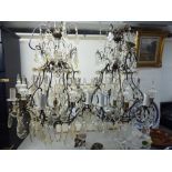 A pair of eight branch wrought metal chandeliers with multiple cut crystal pendants 26''spread