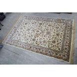 A Persian rug with floral motifs on a cream coloured ground 60'' x 88'' CA