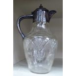 An Edwardian decoratively slice and facet cut glass wine jug of baluster form with a silver plated