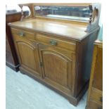 A 1920s oak sideboard with a bevelled mirror back,