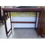 A 1960/70s McIntosh rosewood tea table, the rotating,