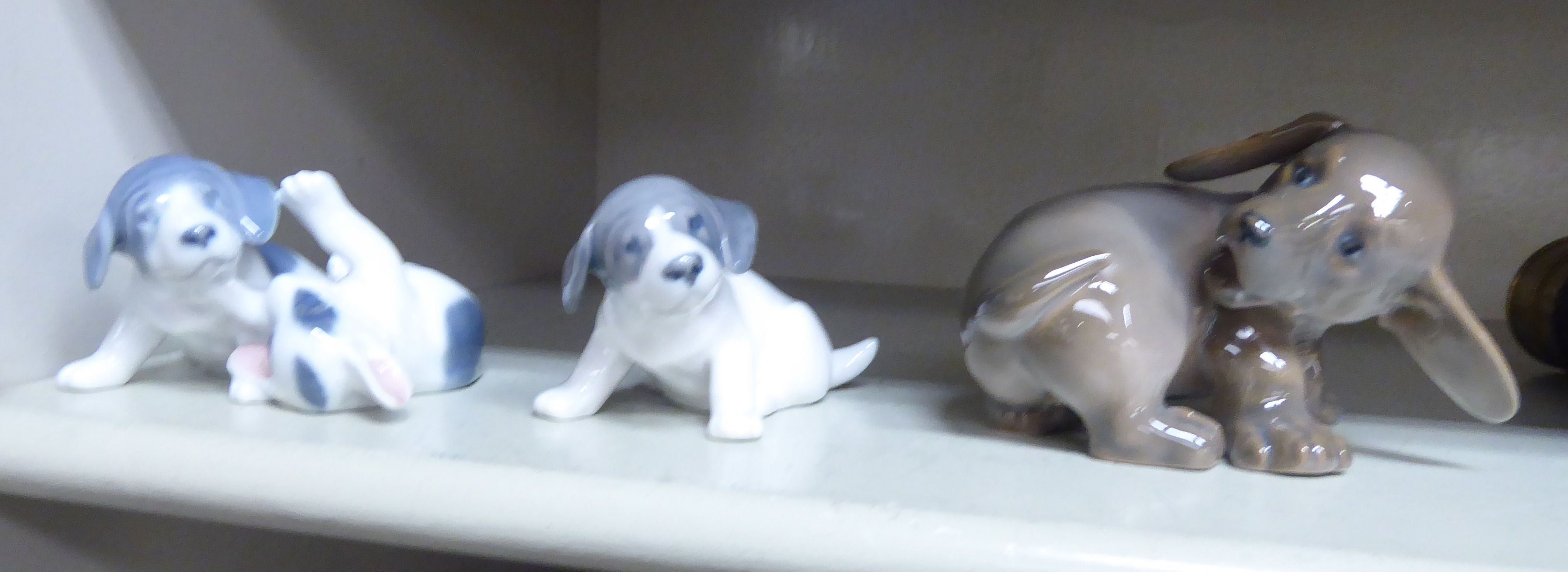 Three Royal Copenhagen porcelain models, viz. a playful puppy No.