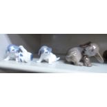 Three Royal Copenhagen porcelain models, viz. a playful puppy No.