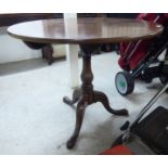 A George III mahogany pedestal table, the tip-top over a baluster column,