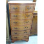 A modern yew wood serpentine front six drawer tallboy,