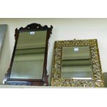 An early 20thC Chippendale design mahogany framed mirror 24'' x 15''; and a bevelled mirror,