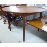 A 1970s teak extending dining table,