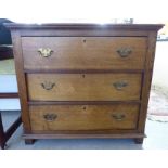 A 1920s light oak three drawer dressing chest,