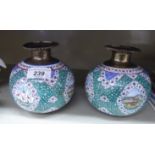 A pair of West Asian painted enamelled white metal vases of bulbous form with narrow necks and