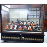 A collection of fifteen modern fabric covered Japanese miniature dolls,