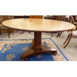 A mid Victorian oak breakfast table, the top on a hexagonal column and a platform base,