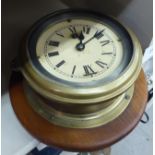 A late Victorian brass cased bulkhead timepiece;