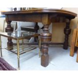 A 1920s oak dining table, the planked top with rounded corners,