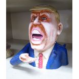 A modern novelty cast and patinated money box, fashioned as Donald Trump with an articulated arm 6.