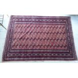 A Turkoman rug with three columns of sixteen guls on a red ground 48'' x 70'' BSR