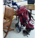 A Hill-Billy battery powered golf trolley; a selection of irons and woods;