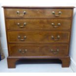 An early 20thC crossbanded string and ebony inlaid mahogany four drawer dressing chest,