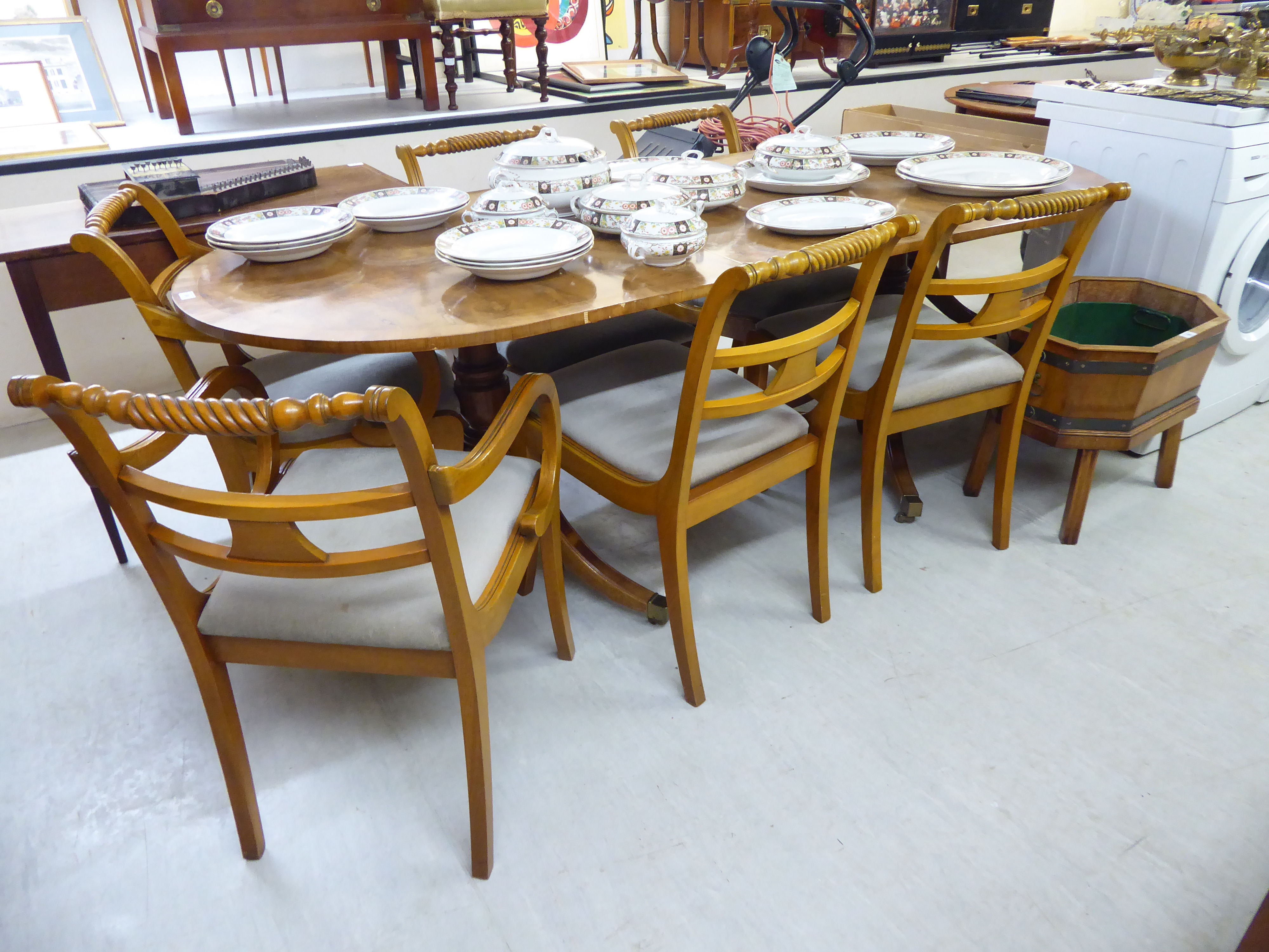 A modern Regency style yew wood twin pedestal dining table,