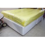 A modern fabric covered ottoman double bed base with a Beds-Direct Heli-bed mattress Simone' range