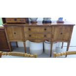 A modern Regency style yew wood sideboard with two central drawers, flanked by two panelled doors,