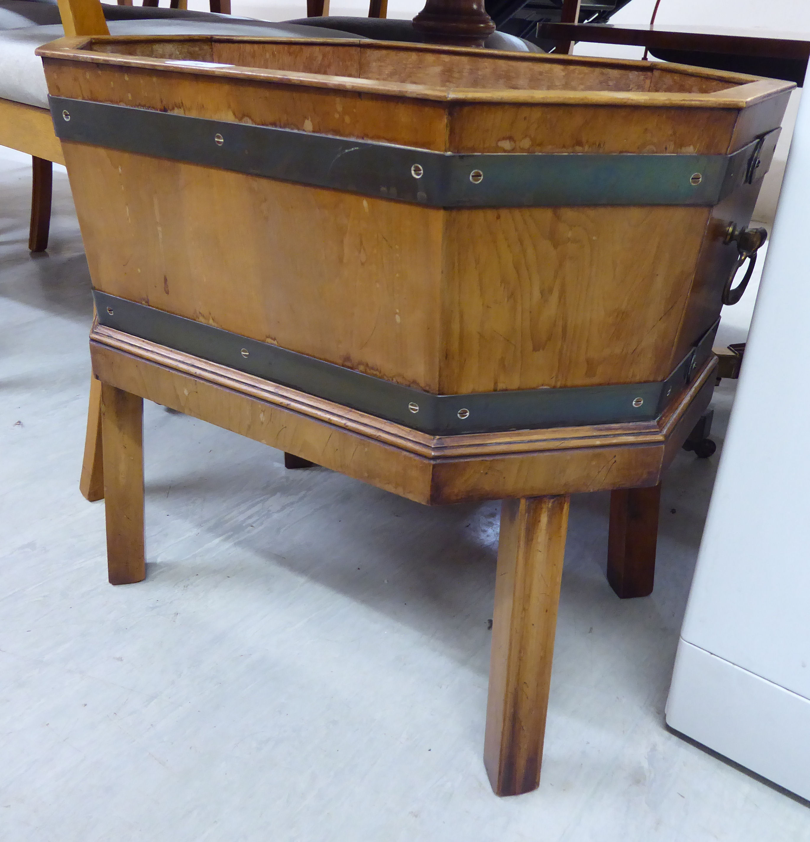 A modern Georgian style yew wood and brass banded planter of elongated, octagonal form,