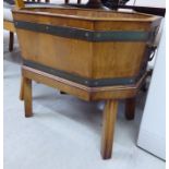 A modern Georgian style yew wood and brass banded planter of elongated, octagonal form,