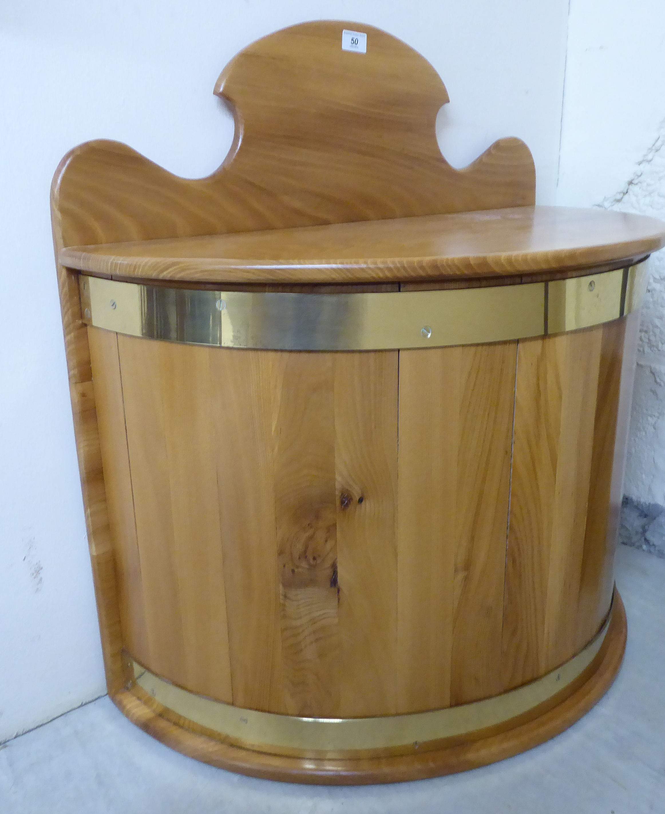 A modern bleached pine demi-lune bin with a hinged lid, enclosing a removable steel liner,