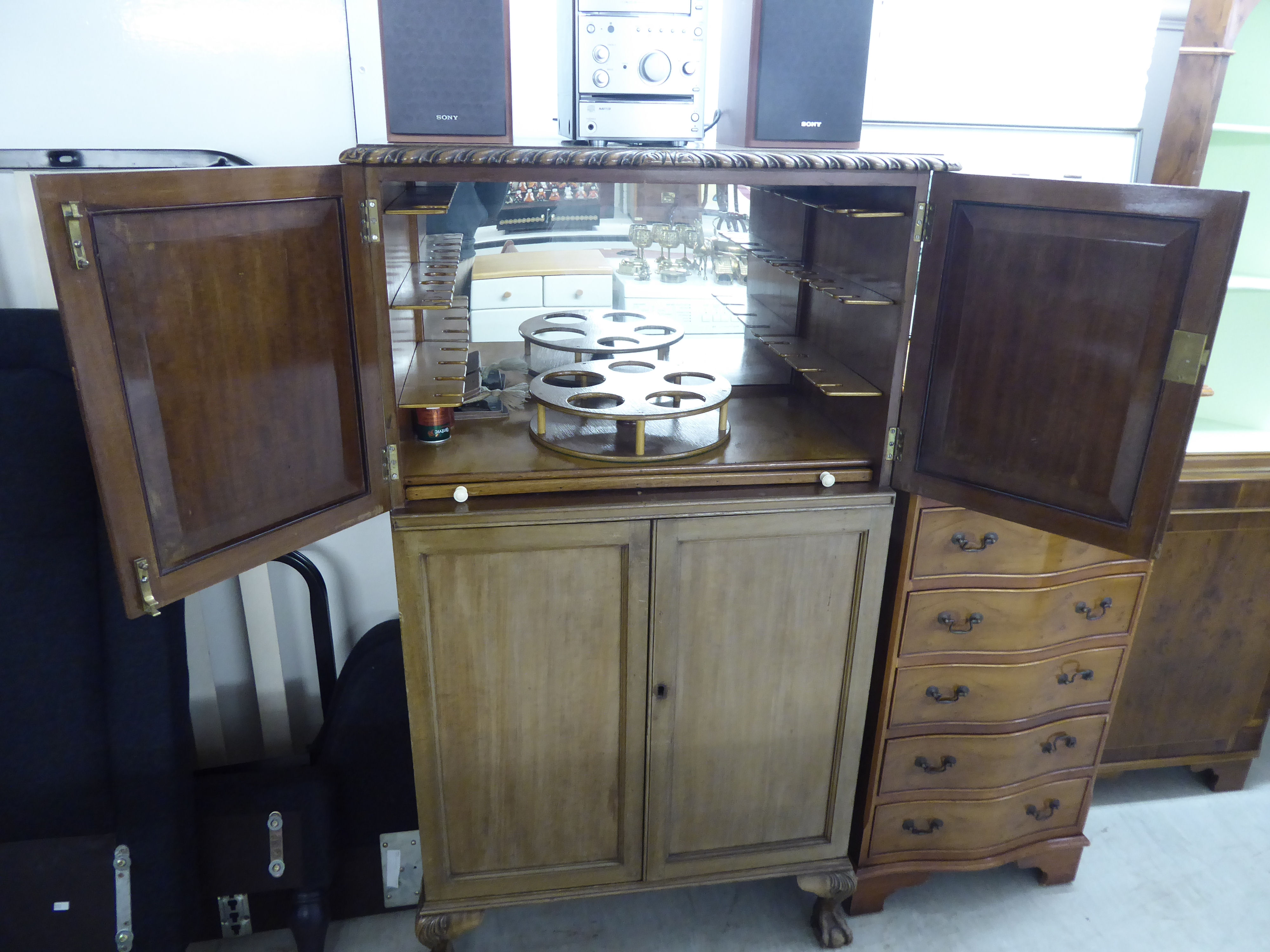 A mid 20thC mahogany cocktail cabinet with two short doors, enclosing a part-fitted interior, - Image 2 of 3