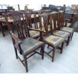 A set of eight early 20thC mahogany framed Chippendale inspired dining chairs with yoke crests,
