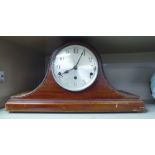 A 1930s mahogany finished, cased mantle clock; faced by a brushed steel Arabic dial,
