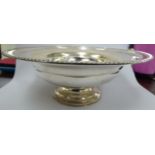 A silver fruit bowl with a gadrooned, everted rim,