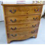 A modern yew wood bow front, four drawer dressing chest,