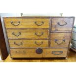 A 1920/30s rustically constructed oak collector's chest with an arrangement of six drawers,