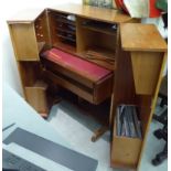 A 1970s teak home-office desk, the fitted interior enclosed by two doors,