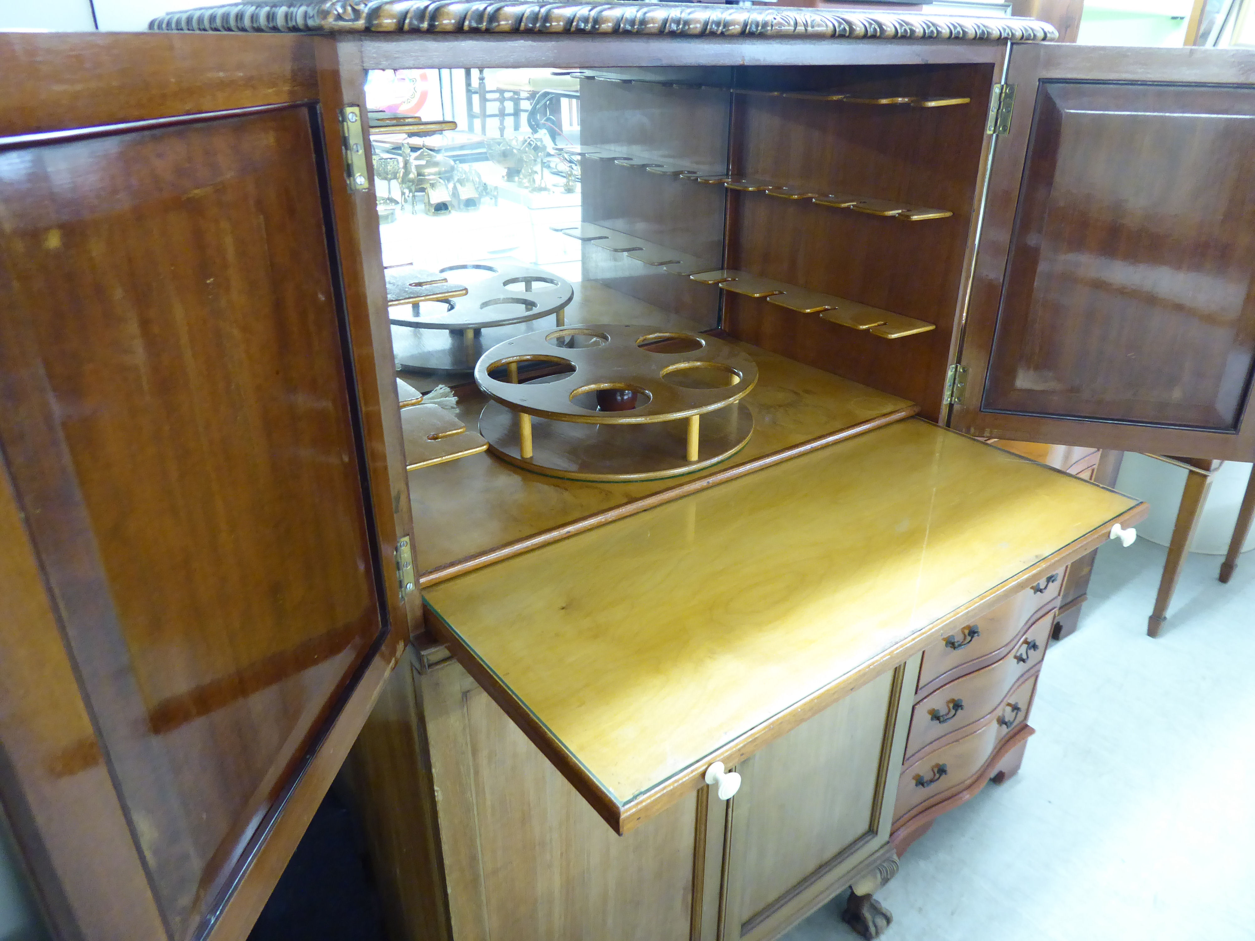 A mid 20thC mahogany cocktail cabinet with two short doors, enclosing a part-fitted interior, - Image 3 of 3