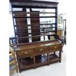 A late 18thC country made oak dresser, the superstructure comprising three open shelves,