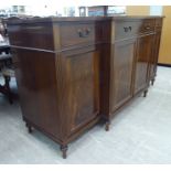 A modern Regency style crossbanded mahogany breakfront sideboard, comprising three in-line drawers,