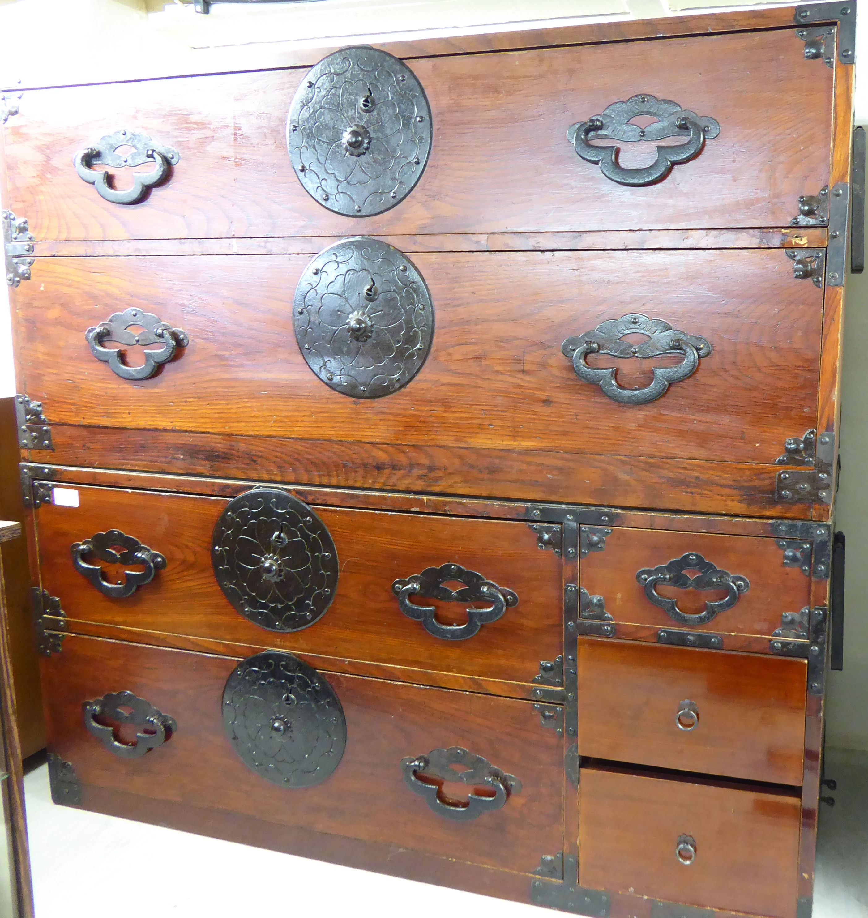 Two similar mid 20thC Orientally inspired stained pine chests with applied iron mounts 19''h