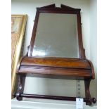 An Edwardian mahogany framed toilet mirror, the broken arch pediment, over a rectangular plate,