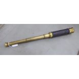 An early/mid 20thC brass four section telescope with a hide bound handgrip 20''L extended