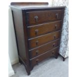 A 1930s stained oak five drawer dressing chest,