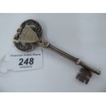 An Edwardian silver presentation key, set with an engraved shield shaped plaque,