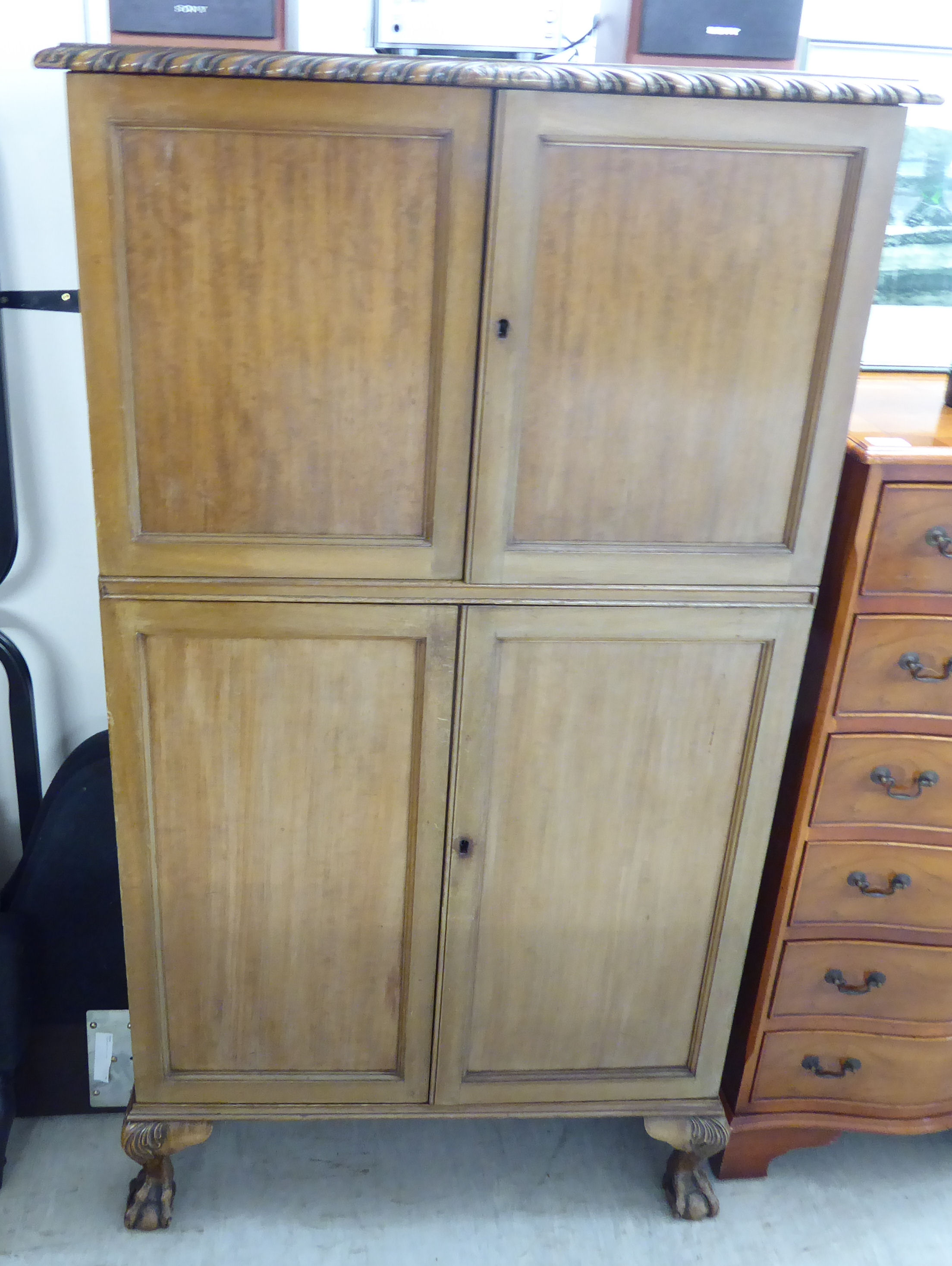 A mid 20thC mahogany cocktail cabinet with two short doors, enclosing a part-fitted interior,