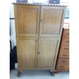 A mid 20thC mahogany cocktail cabinet with two short doors, enclosing a part-fitted interior,