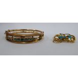 A 9ct gold hinged bangle, set with graduated green stones (three missing); and a 9ct gold brooch,