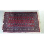 A Turkoman rug on a red ground 41'' x 50'' BSR