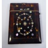 A late Victorian tortoiseshell card case with a hinged lid,