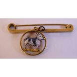 A 9ct gold bar brooch with an open framed, circular pendant, featuring an enamelled,